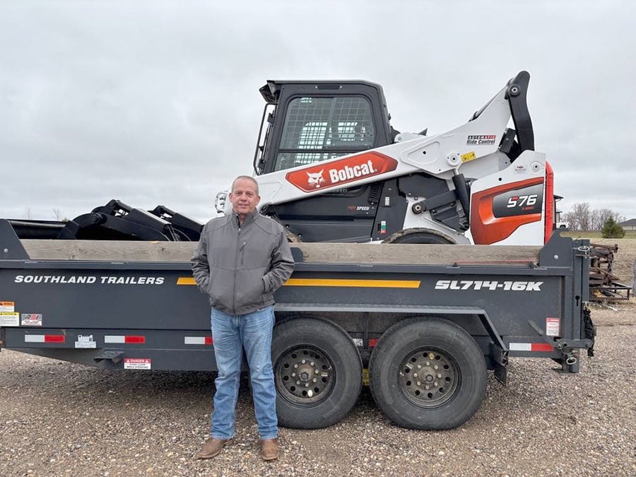 bobcat skidsteer on a trailer with a customer