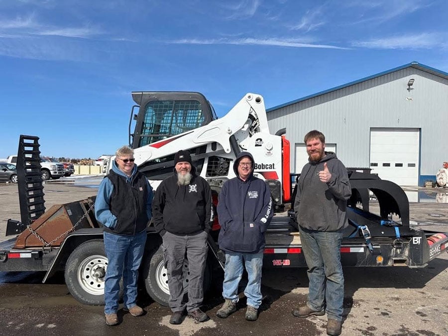 bobcat skidsteer on a trailer with customers