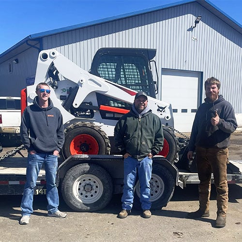 Matt Ascheman with 2 customers and a bobcat skidsteer