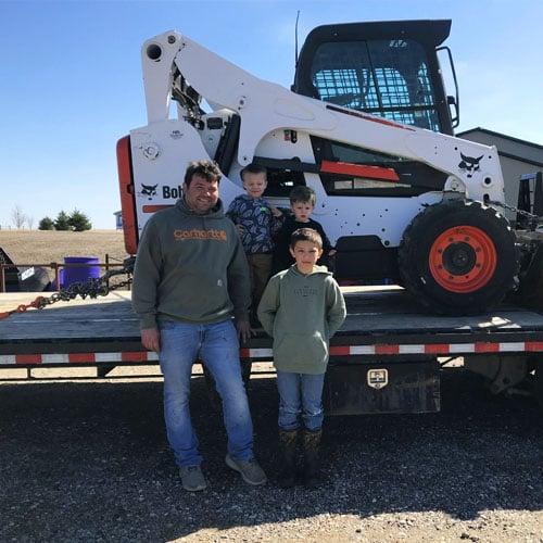 customer with family buying a bobcat skidsteer